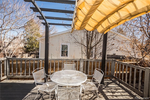 wooden terrace featuring outdoor dining space