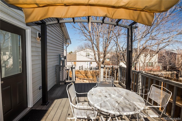 wooden deck featuring outdoor dining space and a residential view