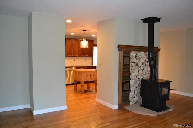 living room with light wood-type flooring and a wood stove