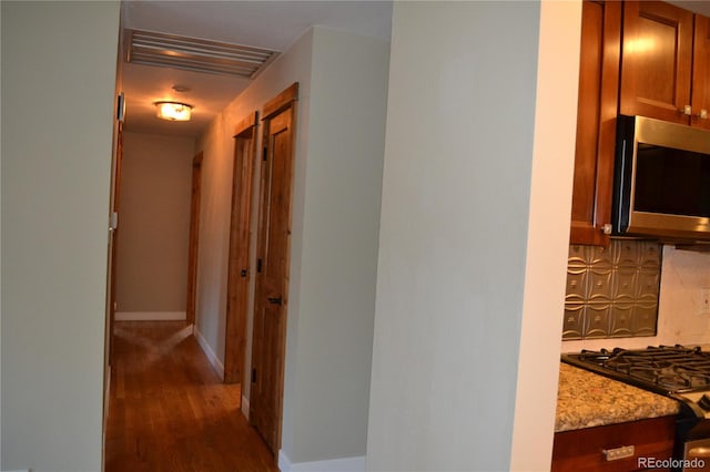 hallway with dark hardwood / wood-style flooring