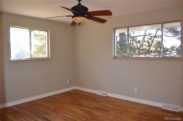 unfurnished room with hardwood / wood-style flooring and ceiling fan