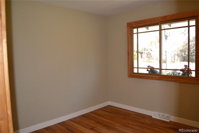 unfurnished room with wood-type flooring