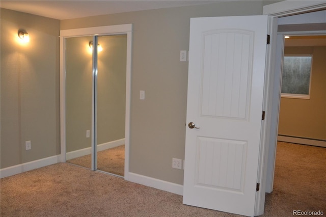 unfurnished bedroom with baseboard heating and light carpet