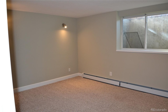 spare room with carpet and a baseboard radiator