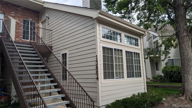 13854 E Lehigh Ave Unit D, Aurora, CO 80014 - view of side of home with stairs and a chimney