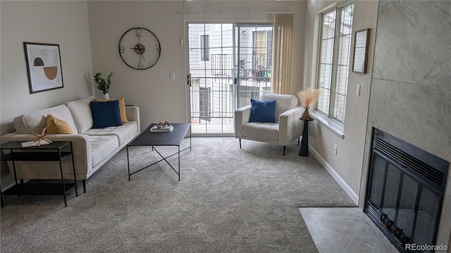 13854 E Lehigh Ave Unit D, Aurora, CO 80014 - carpeted living area with healthy amount of natural light, a fireplace with flush hearth, and baseboards