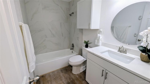 13854 E Lehigh Ave Unit D, Aurora, CO 80014 - bathroom featuring vanity, wood finished floors, bathtub / shower combination, and toilet