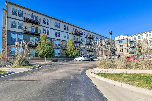 13598 Via Varra Unit 301, Broomfield, CO 80020 - view of asphalt road with curbs, street lighting, and sidewalks