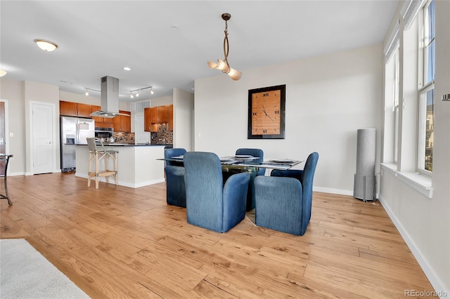 13598 Via Varra Unit 301, Broomfield, CO 80020 - dining room featuring plenty of natural light, light wood finished floors, and a desk