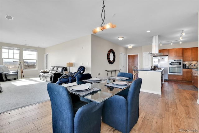 13598 Via Varra Unit 301, Broomfield, CO 80020 - dining space featuring light wood-style floors