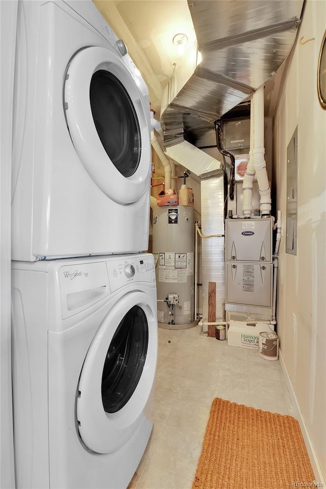 13598 Via Varra Unit 301, Broomfield, CO 80020 - laundry area featuring gas water heater, stacked washer / drying machine, and light tile patterned floors
