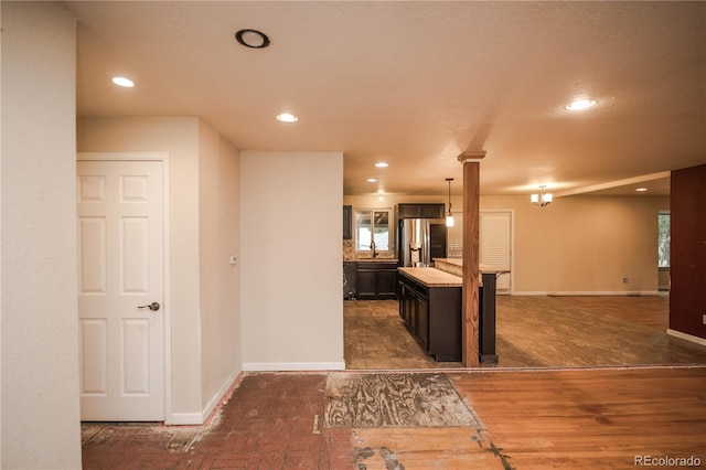 200 Garrison St, Lakewood, CO 80226 - kitchen with stainless steel fridge, recessed lighting, healthy amount of natural light, light countertops, and a kitchen island