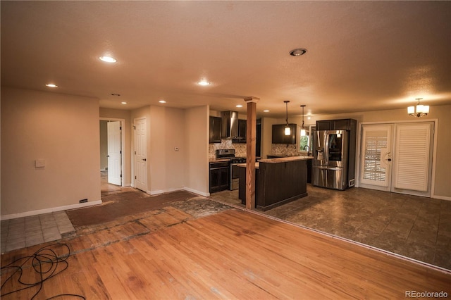 200 Garrison St, Lakewood, CO 80226 - kitchen with stainless steel appliances, wall chimney range hood, decorative columns, recessed lighting, and light countertops