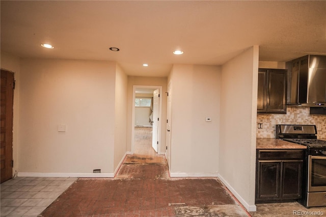 200 Garrison St, Lakewood, CO 80226 - kitchen featuring stainless steel gas range, wall chimney exhaust hood, recessed lighting, tasteful backsplash, and dark brown cabinets