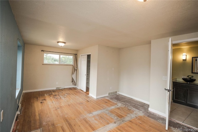200 Garrison St, Lakewood, CO 80226 - spare room with a textured ceiling and hardwood / wood-style flooring