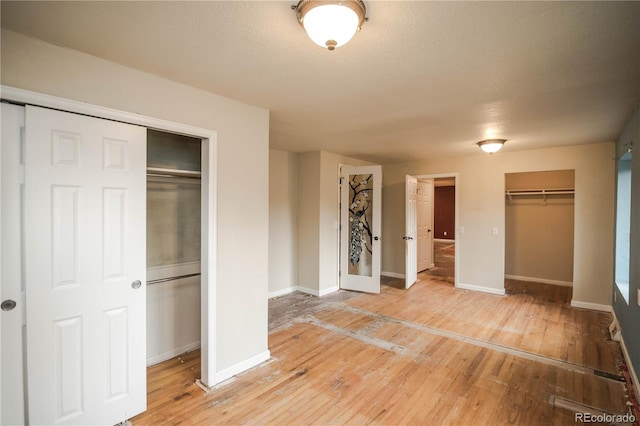 200 Garrison St, Lakewood, CO 80226 - unfurnished bedroom with light wood finished floors and a textured ceiling
