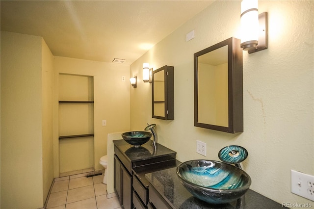 200 Garrison St, Lakewood, CO 80226 - full bath with double vanity, tile patterned flooring, and built in shelves