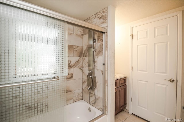 200 Garrison St, Lakewood, CO 80226 - full bathroom featuring enclosed tub / shower combo, tile patterned floors, and vanity