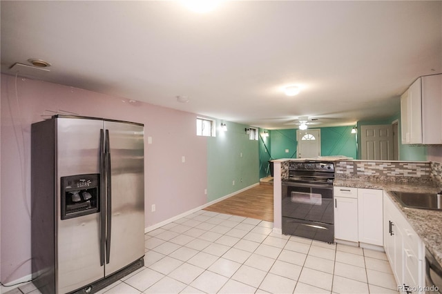 200 Garrison St, Lakewood, CO 80226 - kitchen with stainless steel refrigerator with ice dispenser, black electric range oven, a peninsula, white cabinets, and light tile patterned floors