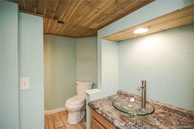 200 Garrison St, Lakewood, CO 80226 - bathroom with vanity, wood ceiling, and wood finished floors