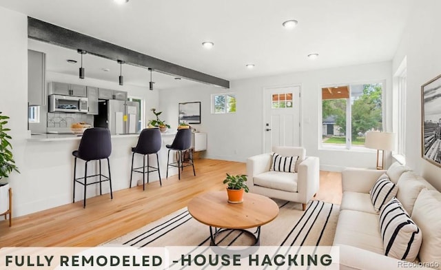 4701 E Jewell Ave, Denver, CO 80222 - living area with beamed ceiling, light wood-style floors, recessed lighting, and baseboards