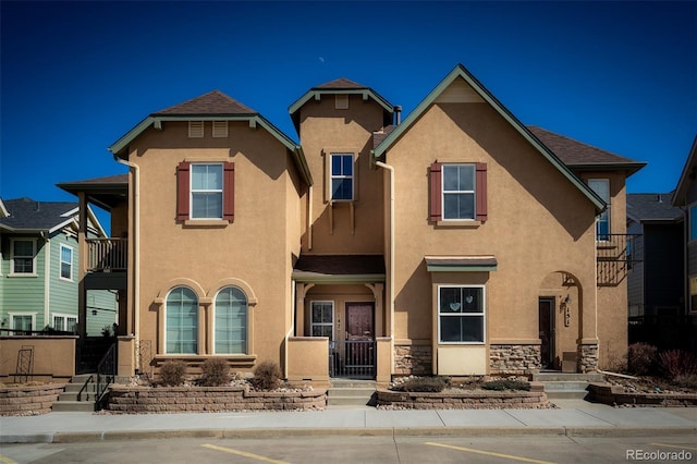 view of front of house with stone siding and stucco siding