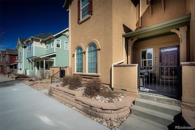 entrance to property featuring stucco siding