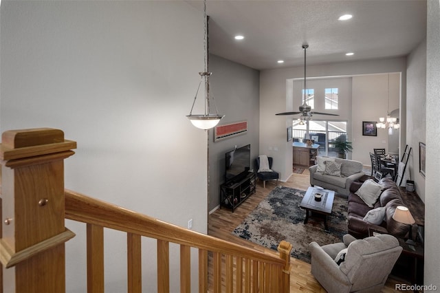 living room with a ceiling fan, recessed lighting, and wood finished floors