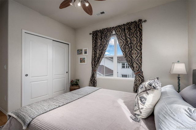 bedroom featuring ceiling fan, a closet, and visible vents