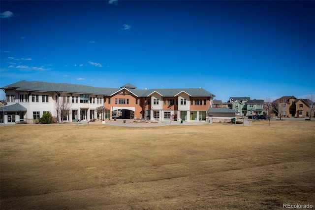 exterior space with a residential view and a lawn