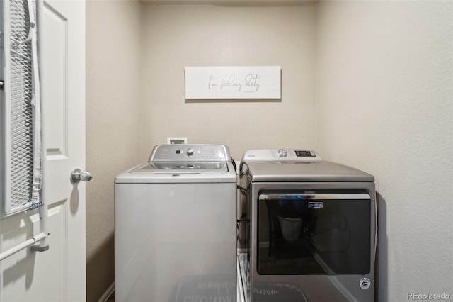 laundry area with laundry area and washer and clothes dryer