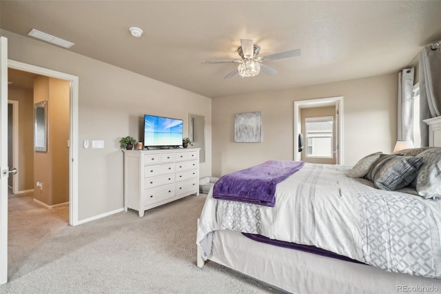 bedroom featuring light carpet, a ceiling fan, and baseboards