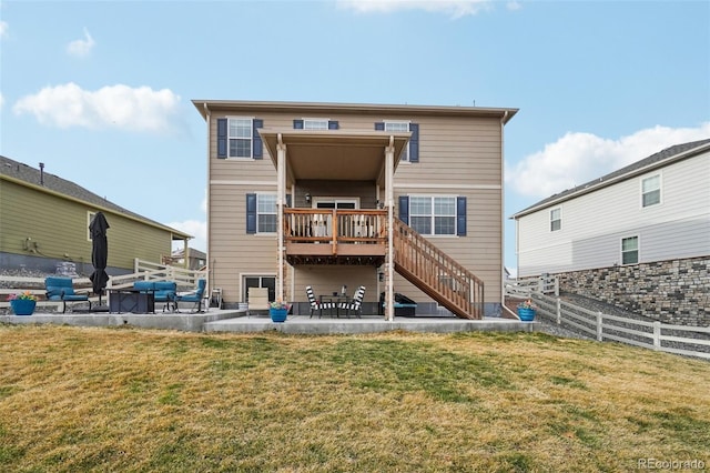 back of property featuring fence, stairs, a yard, a deck, and a patio