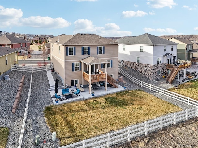 rear view of house featuring stairs, a patio, a fenced backyard, and a residential view