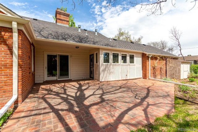 3756 S Forest Way, Denver, CO 80237 - rear view of property with brick siding, a chimney, a shingled roof, and a patio area