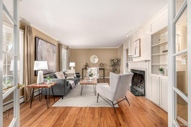 3756 S Forest Way, Denver, CO 80237 - living room featuring light wood-style floors, ornamental molding, and a high end fireplace
