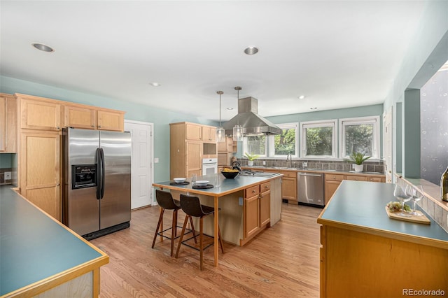 3756 S Forest Way, Denver, CO 80237 - kitchen featuring stainless steel appliances, island exhaust hood, light brown cabinets, light wood-style floors, and recessed lighting