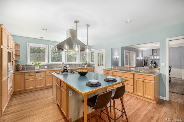 3756 S Forest Way, Denver, CO 80237 - kitchen featuring island range hood, light wood-style flooring, decorative backsplash, stainless steel gas cooktop, and recessed lighting