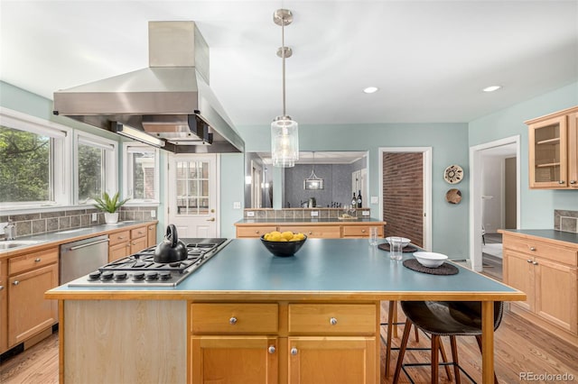 3756 S Forest Way, Denver, CO 80237 - kitchen with island exhaust hood, a kitchen island, appliances with stainless steel finishes, light wood finished floors, and light brown cabinetry