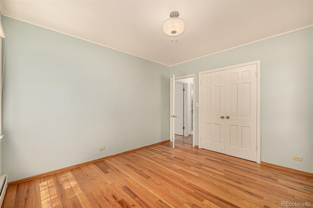 3756 S Forest Way, Denver, CO 80237 - empty room with light wood-type flooring, crown molding, a baseboard heating unit, and baseboards