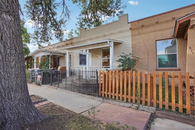 2121 W 33rd Ave, Denver, CO 80211 - view of front facade with a fenced front yard and stucco siding