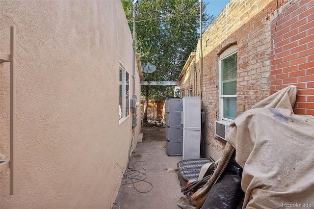 2121 W 33rd Ave, Denver, CO 80211 - view of side of property featuring stucco siding, brick siding, and cooling unit