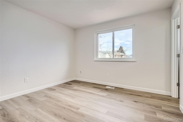 spare room with light hardwood / wood-style flooring