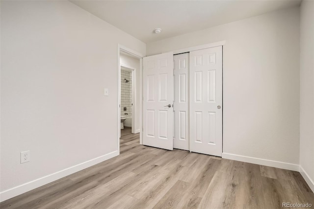 unfurnished bedroom with light hardwood / wood-style floors and a closet