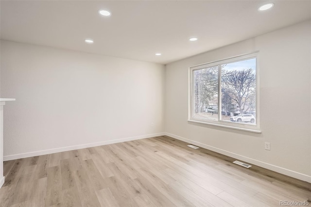 empty room with light hardwood / wood-style floors