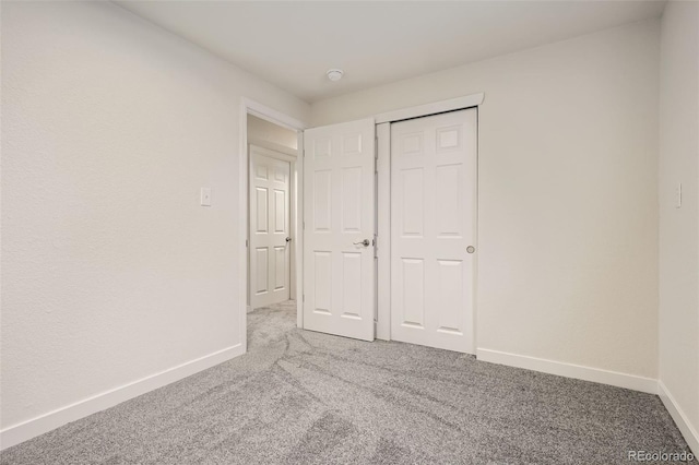 unfurnished bedroom with a closet and carpet