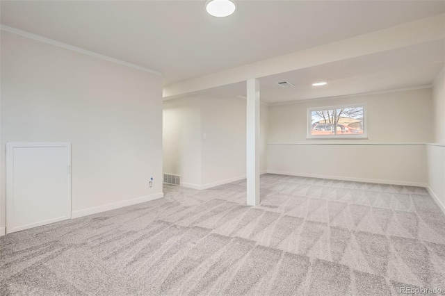 basement with ornamental molding and light carpet