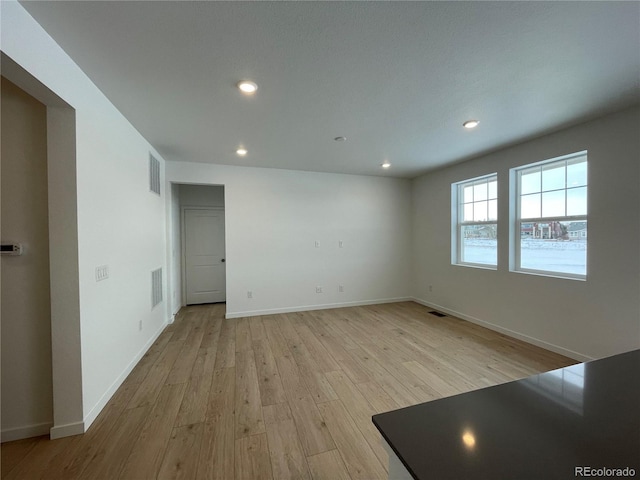 unfurnished room with light hardwood / wood-style flooring