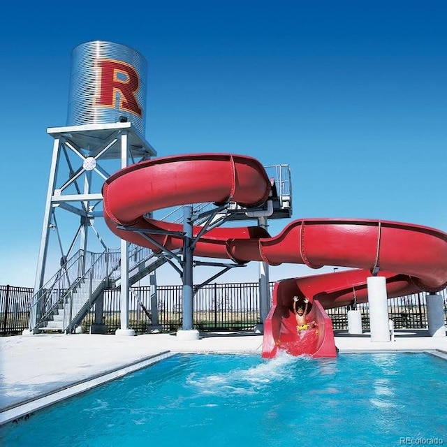 view of pool with a water slide