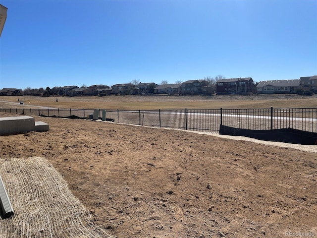 view of yard featuring a residential view and fence